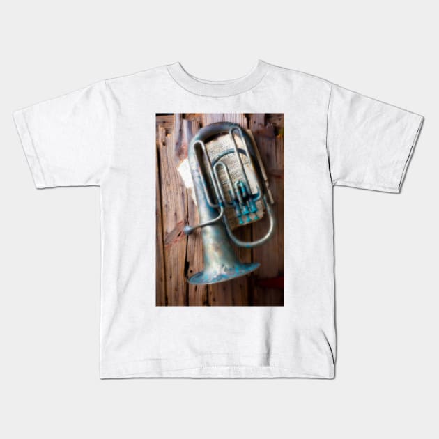 Weathered Tuba Hanging On Old Wall Kids T-Shirt by photogarry